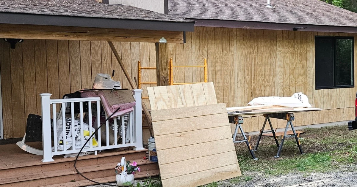 Front wall rebuild with new exterior panels, scaffolding and construction materials still on site